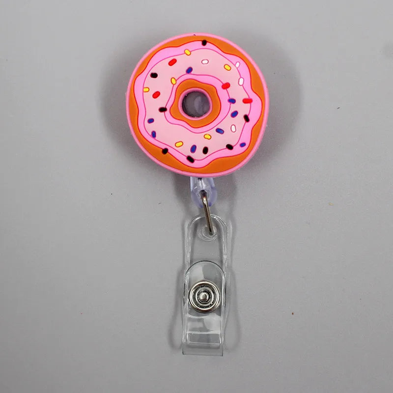 Add fun to your work or school day with this adorable 1PC Donuts & Cake Retractable Badge Reel. Perfect for kids, students, or nurses, it features a durable ABS reel, silica gel clip, and a 60cm retractable length. A cute, practical way to carry your ID or name tag with style!